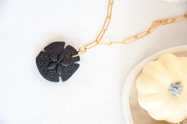 Black Sand Dollar Pendant Necklace by MK Designs